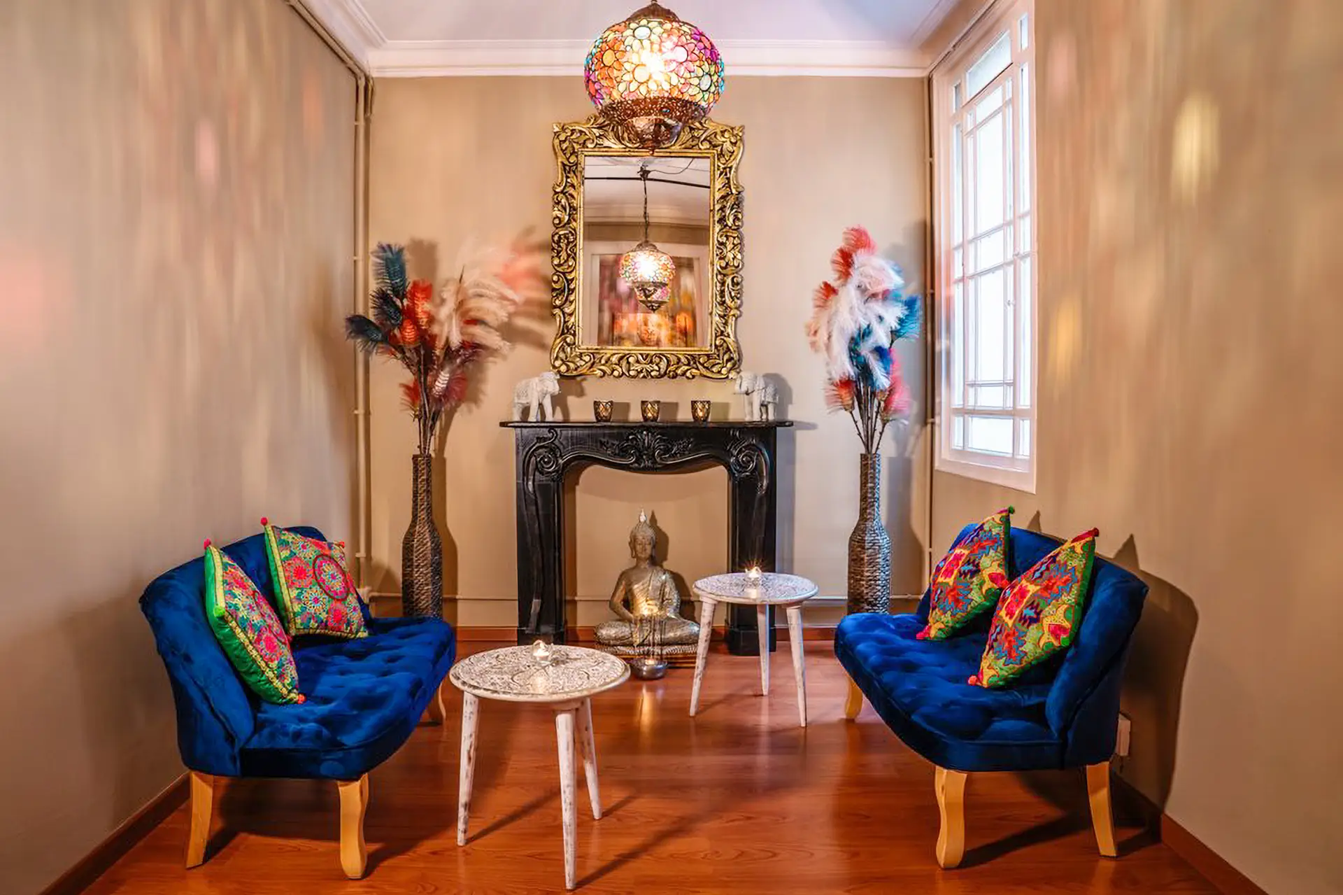 Salle d'attente avec fauteuils bleus, miroir doré et Bouddha